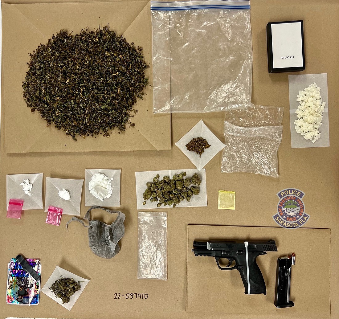 A stolen weapon, powder cocaine and crack cocaine were among items seized by Sarasota police in a drug raid last Friday. (Courtesy Sarasota Police Department)