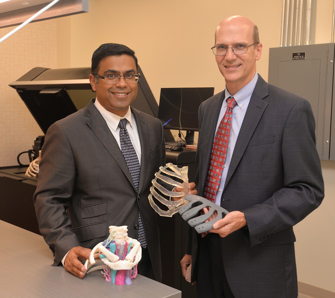 Dr. Mathew Thomas, director of thoracic surgery at Mayo Clinic in Florida at Jacksonville, and Robert Pooley, a medical physicist, are creating 3D models of body parts to help doctors prepare for operations. (Dede Smith)