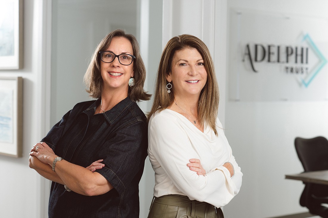 Katie Pemble and Gentry Barnett Byrnes received the charter for St. Petersburg-based Adelphi Trust Co. Aug. 12 (Courtesy photo)