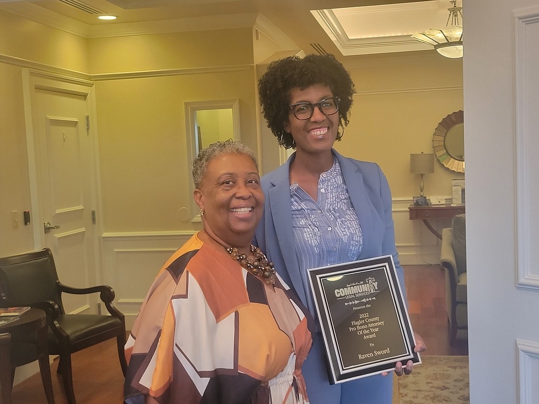 Lena Hopkins (left) of Community Legal Services of Mid-Florida, presents Attorney Raven Sword (right) with the Flagler County Pro Bono Attorney of the Year award. Photo by John Walsh