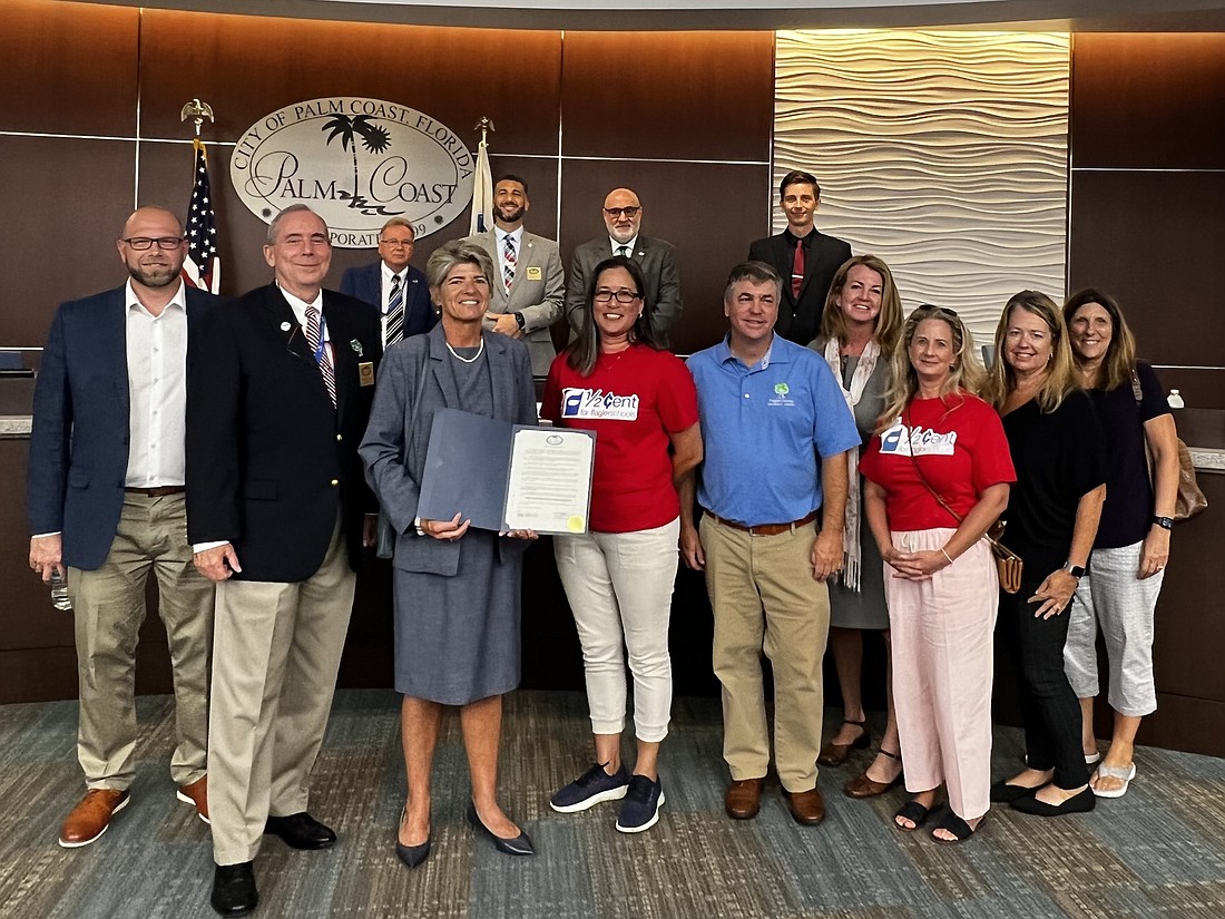Palm Coast Mayor David Alfin (second left) presents proclamation of  support for the half-cent education sales tax. Photo courtesy of the city of Palm Coast