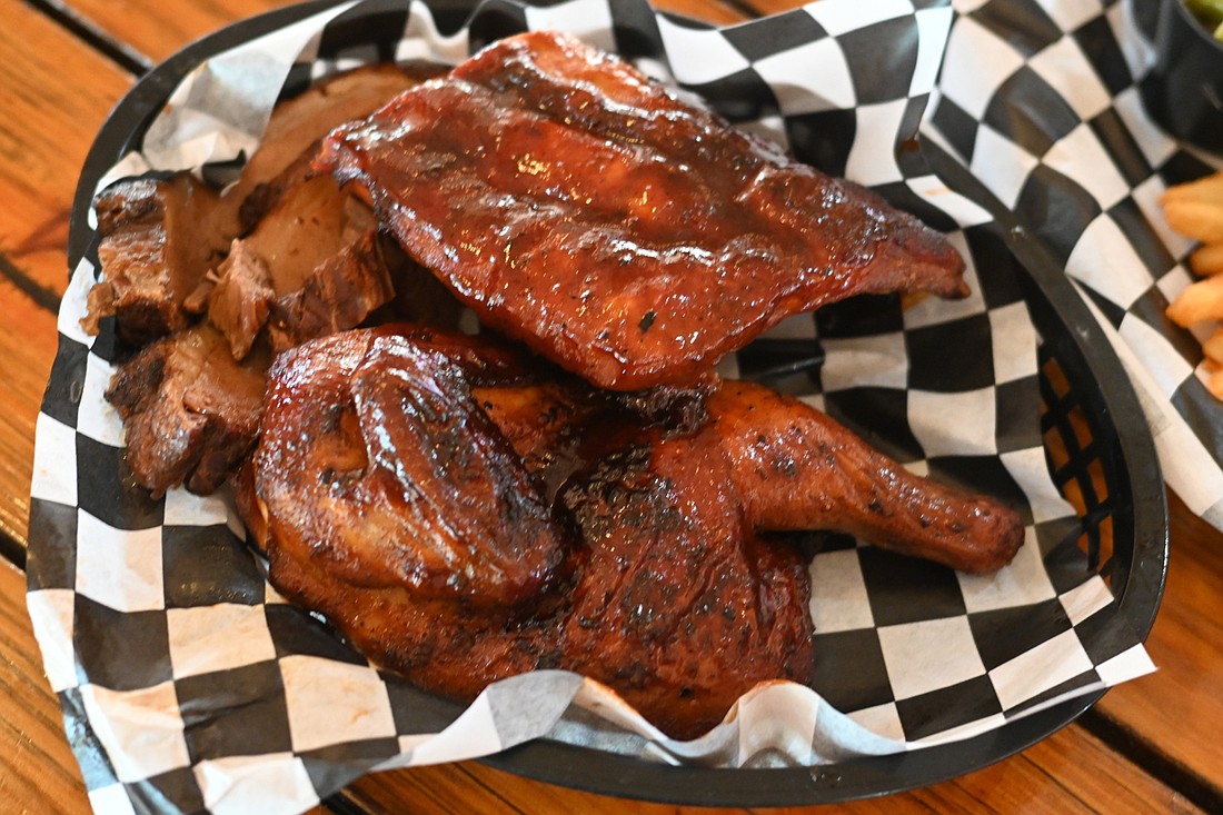 The BBQ Sampler at Stottlemyer&#39;s features chicken, slow-cooked brisket and your choice of baby back or long bone ribs. (Photo by Spencer Fordin)