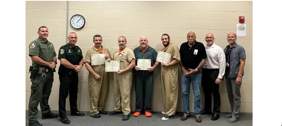 From left to right: Flagler County Sheriff's Office (FCSO) Court & Detention Services Division Programs Deputy Jesse O'Neil and Chief Dan Engert with the graduates and FTC instructor Frank Kasmarski, FTC AGE/CTE. Courtesy photo