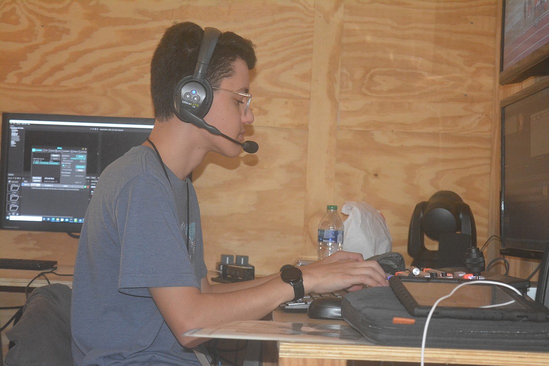 Jackson Hodge, a Braden River sophomore, acts as the director for Pirate Nation Sports Network, choosing when to switch cameras on the broadcast among other duties. (Photo by Ryan Kohn.)