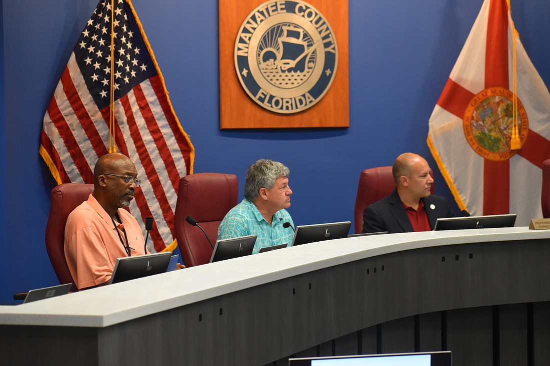 Commissioners Reggie Bellamy, County Administrator Scott Hopes and Commissioner Kevin Van Ostenbridge listen to Commissioner Vanessa Baugh&#39;s comments. (Photo by Ian Swaby)
