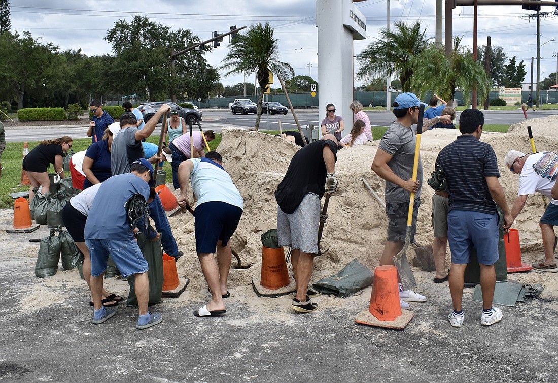 Sarasota County residents fill sandbags at Ed Smith Stadium ahead of Hurricane Ian.