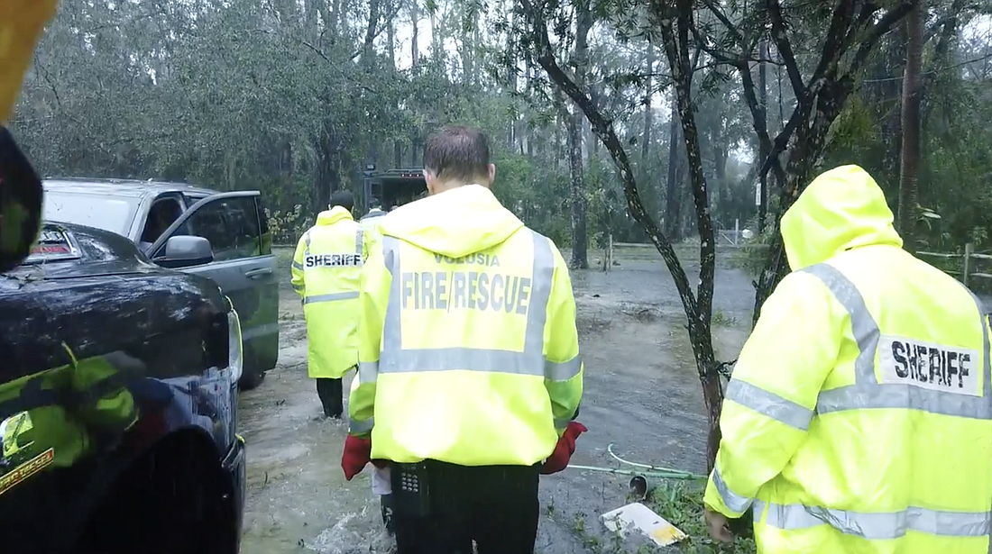 First responders carry a patient during a rescue. Image from a video posted by the Volusia Sheriff's Office