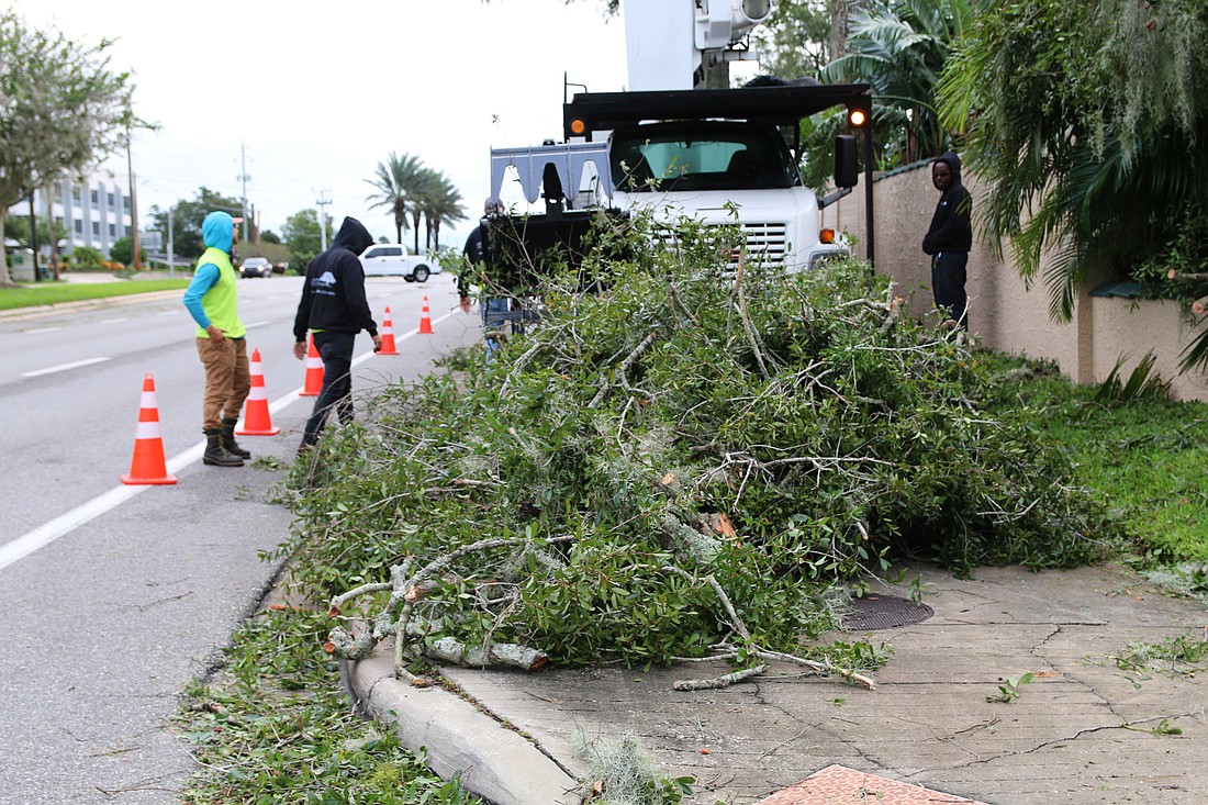 Atlantic Tree Service crews remove a downed tree from a home after Hurricane Ian. Photo by Jarleene Almenas