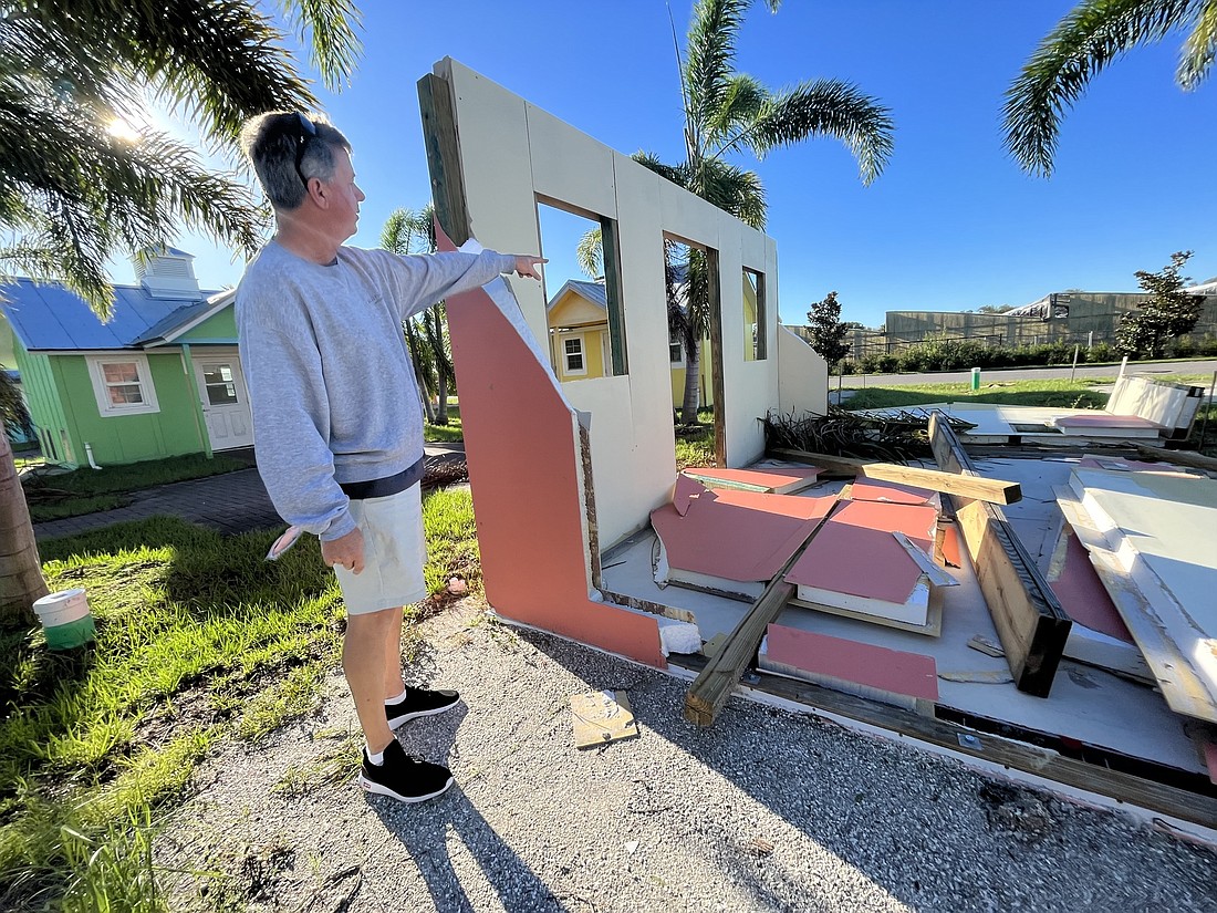 Rob Oglesby, Nate&#39;s Honor Animal Rescue&#39;s development director, says panels from the cottages that were wrecked by Hurricane Ian are salvageable. (Photo by Liz Ramos)