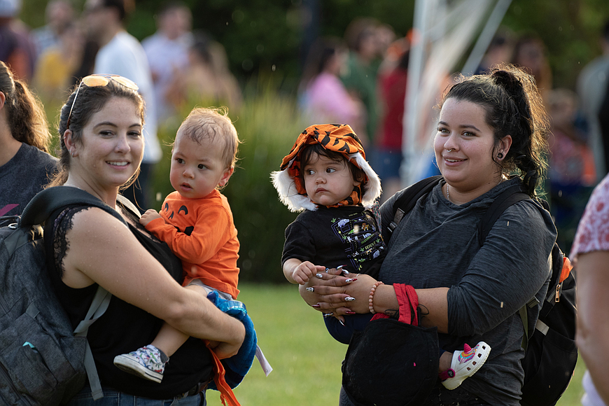 Miranda Owen and 1-year-old Jaxon Collins, with Tati Caso and 1-year-old Ana Merhis during last year's Realty Pros Community Appreciation Night at Rockefeller Gardens. File photo by Jake Montgomery