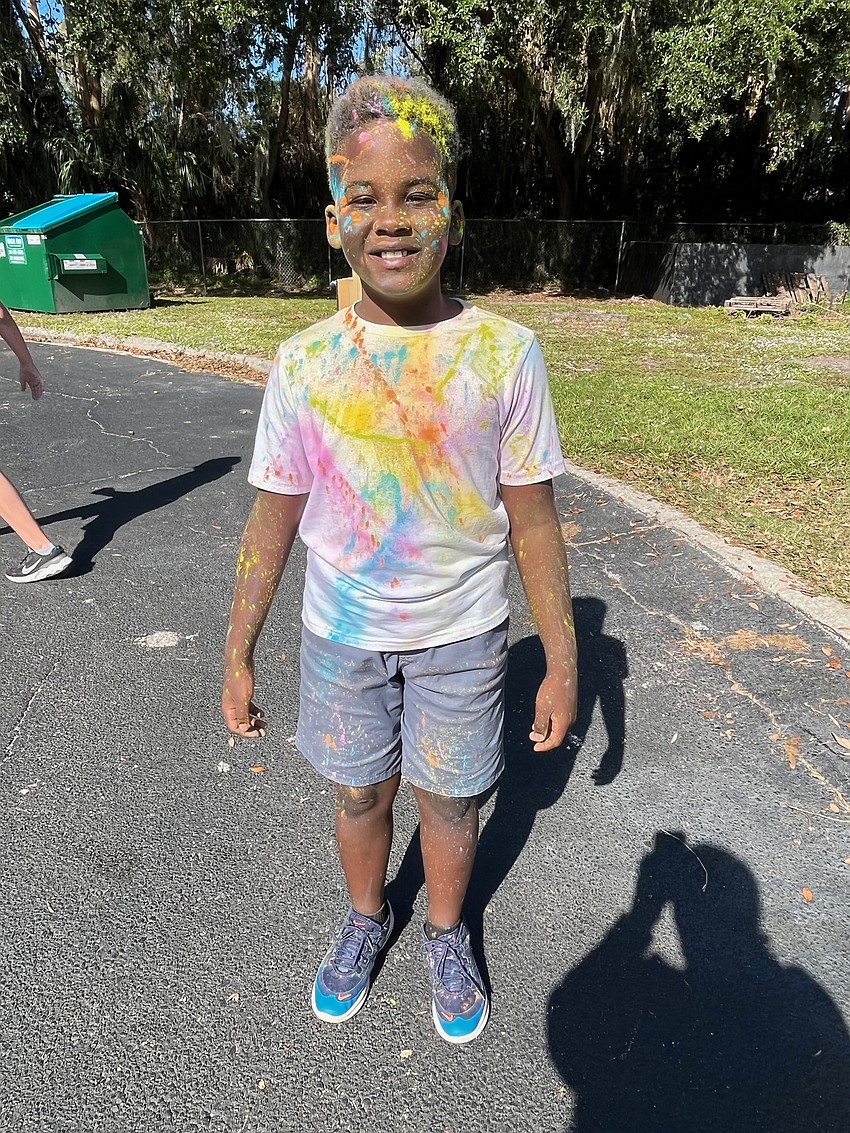Fourth grader Elysee Thelusma not only has different colors all over his shirt but also his face and hair.