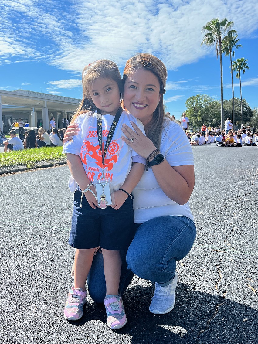 Joy Maria Sanchez, who is in pre-K, is excited to have her mother, Xiomara Sanchez, participate in the color run with her.