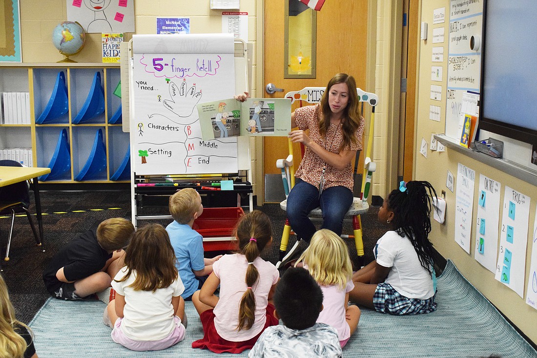 Bella Rubal, a first grade teacher at Gilbert W. McNeal Elementary School, reads to her students. Elementary and middle school students don&#39;t have to make up instructional time missed during Hurricane Ian. (Photo by Liz Ramos)