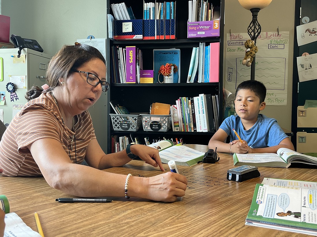 Lissette Estevez, an English to Speakers of Other Languages teacher, helps guide third grader Daniel Perez-Martinez through a math lesson. Teachers are not only there for students educationally but also socially and emotionally.