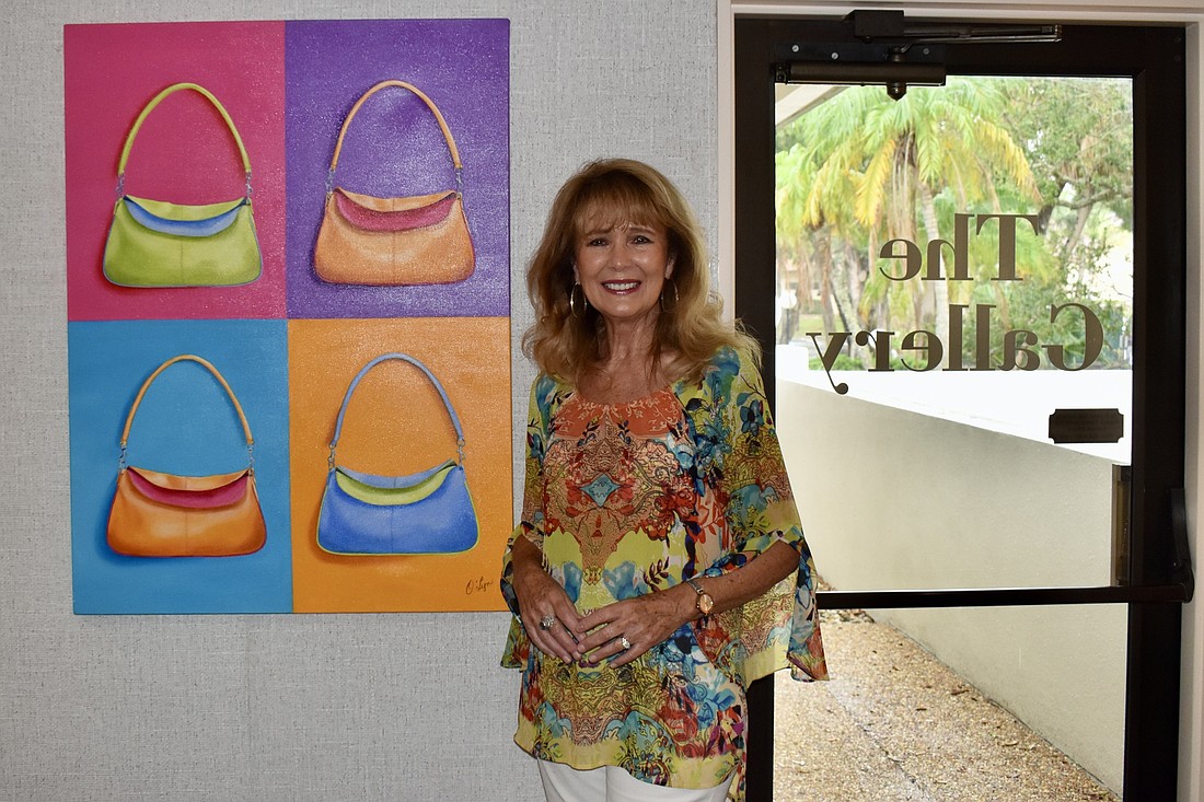 O&#39;Lyn Callahan with her purse painting. She used this painting as a study to learn how to get an object to come off the page. (Photo by Lesley Dwyer)