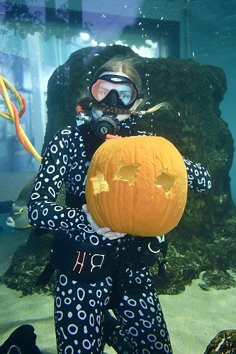 Brooke Welch shows off her underwater pumpkin carving skills. (Photo by Lesley Dwyer)