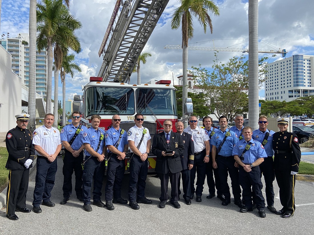 Julius Halas, center, stands with members of the Sarasota County Fire Rescue department at a ceremony on Wednesday. (Courtesy photo)