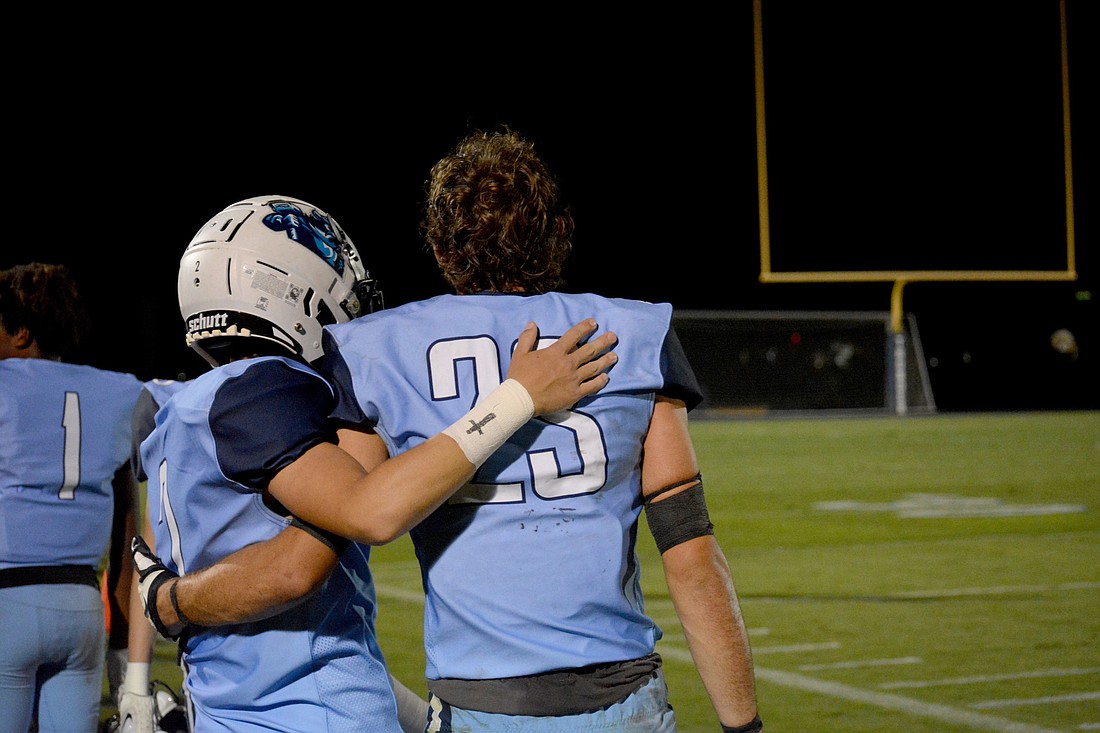 ODA safety Dylan Walker and defensive end Tyler Beck share a hug in the waning moments of the Thunder&#39;s 21-0 loss to St. Stephen&#39;s. (Photo by Ryan Kohn.)