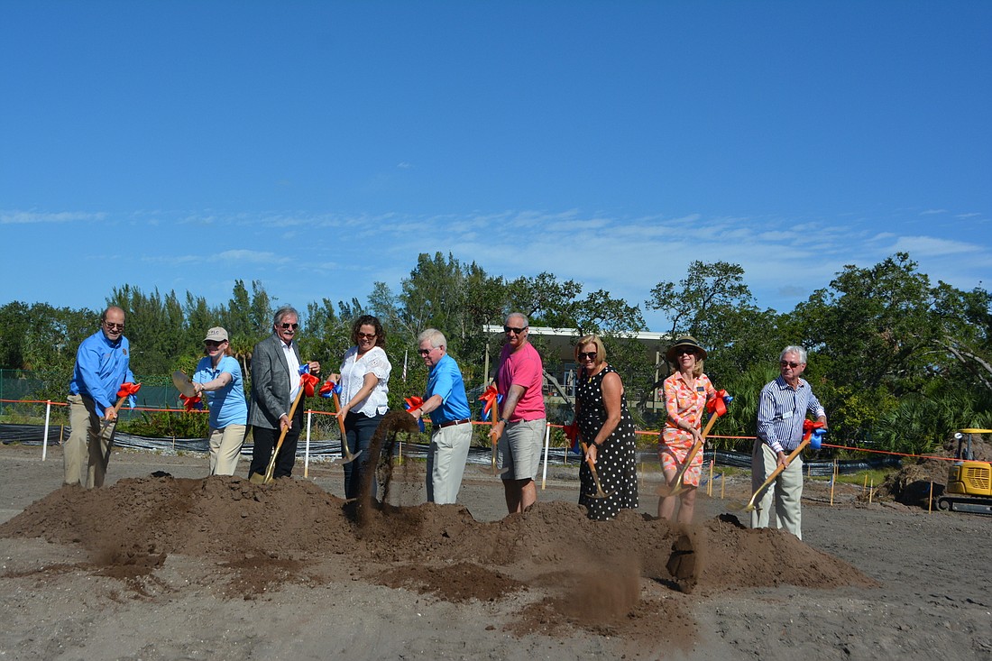 From left to right: Tom Harmer, Penny Gold, Mike Haycock, Sarah Karon, Ken Schneier, Paul Karon, BJ Bishop, Debra Williams and Jim Brown kick off construction on the stage site Monday. (Photo by Lauren Tronstad)