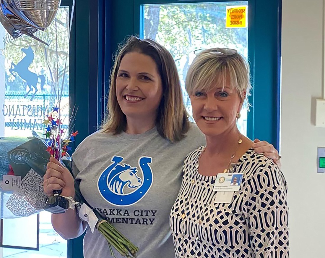 Carol Ricks, principal of Myakka City Elementary School, celebrates after being told  by district employee Annette Codelia that she is the Principal of the Year. (Courtesy photo)