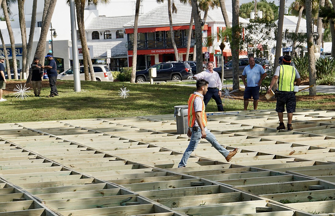 Workers were building the framework for the Winter Festival skating rink on Monday. (Eric Garwood)
