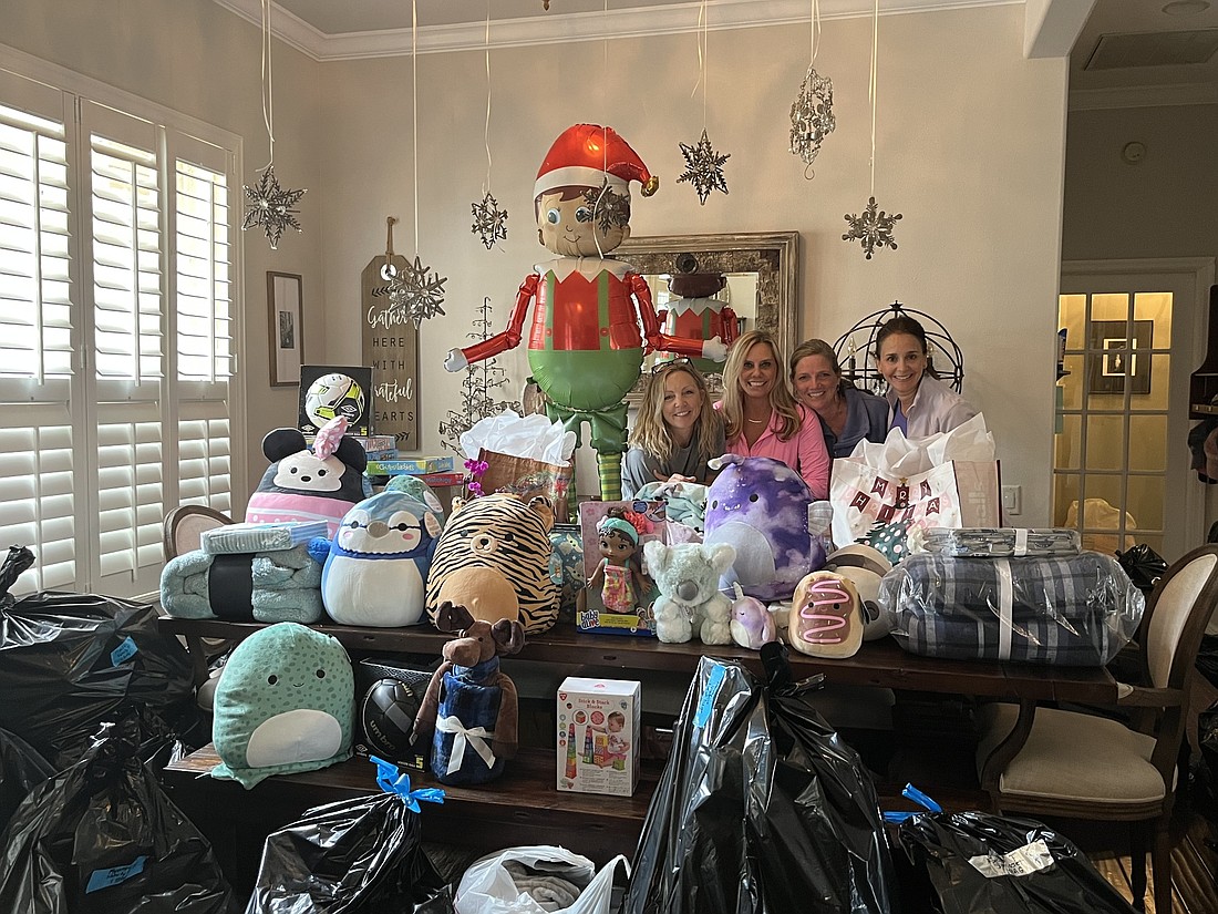 Lakewood Ranch&#39;s North Pole is filled with gifts that Bradenton&#39;s Megan Napolitano and Lakewood Ranch&#39;s Jill Campbell, Beth Grogan and Jo Price are hustling to wrap. (Photo by Liz Ramos)