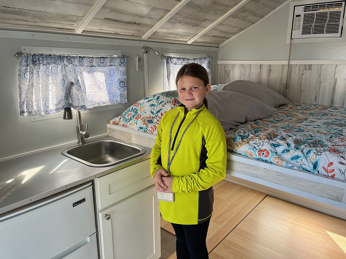 Third grader Raelynn Wilson is surprised to see how much can fit in a tiny house if space is used wisely.
