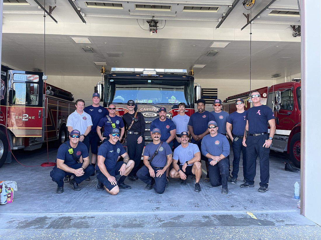 Deputy Chief Paul Wren (back row, fourth from left) and strike team members pose with the Captiva Island Fire Control District staff.