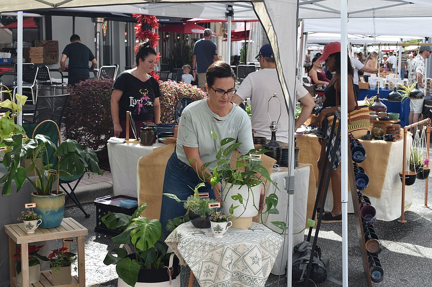 Lakewood Ranch's Carlee Smith, of the plant shop Wally's, adjusts the display.