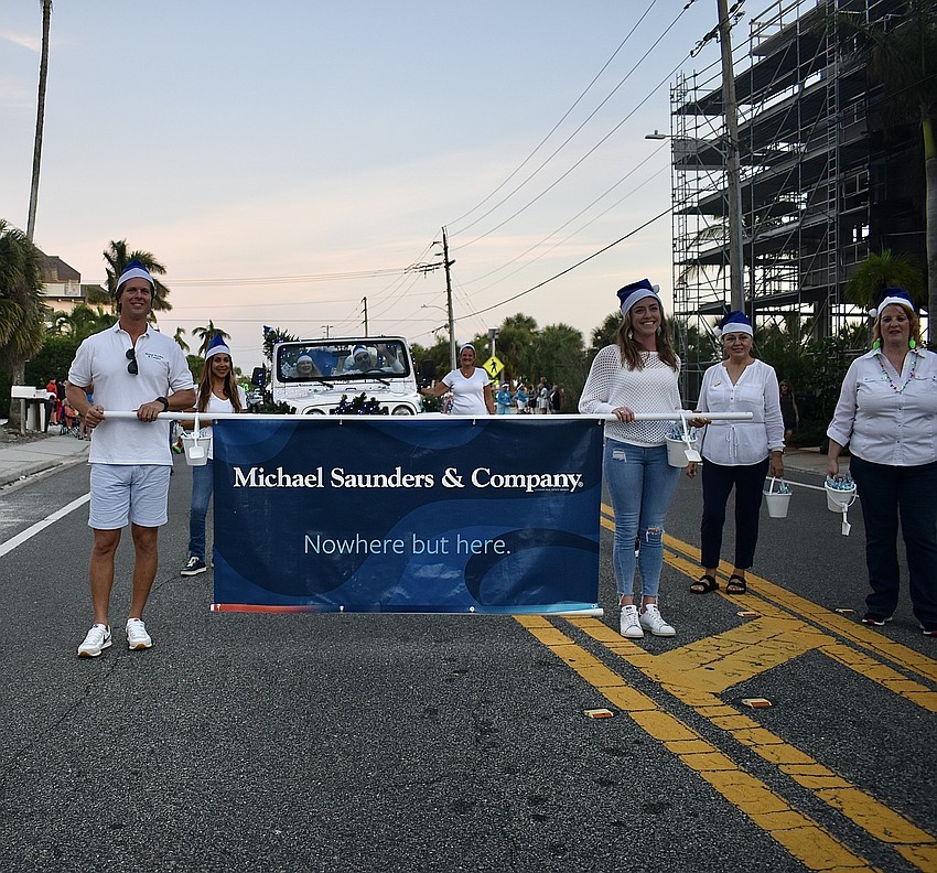 Michael Saunder & Company walk along Ocean Boulevard.