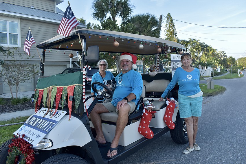 Lorraine Stanford, Mojo Stanford, Tony Standford and Betsy Howard walk with Save Siesta Key float.