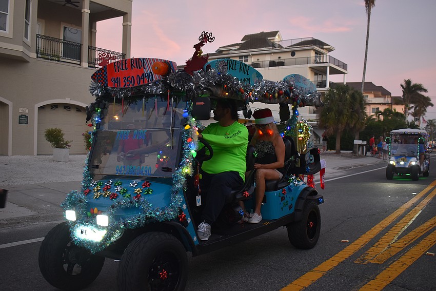 Joe White, Jeneva Hospodarsky and Ian Page pass out goodies to families and children.