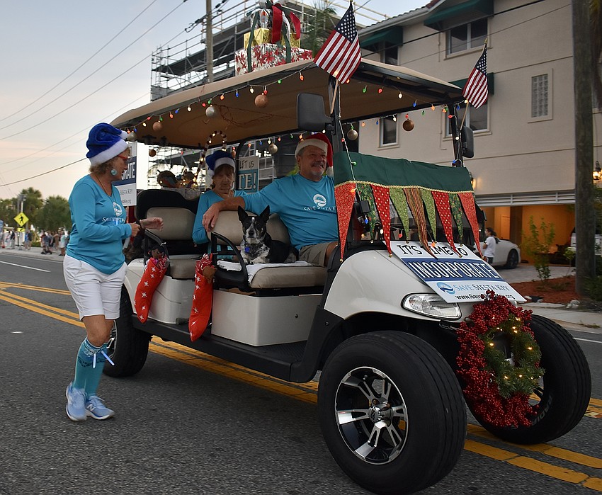 Groups decorate their float with holiday lights in cheery spirit.
