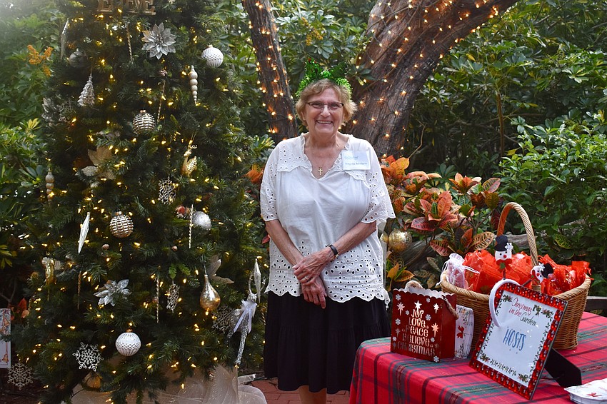 Angela Molaro at the welcome table handing out gift bags to visitors that include 