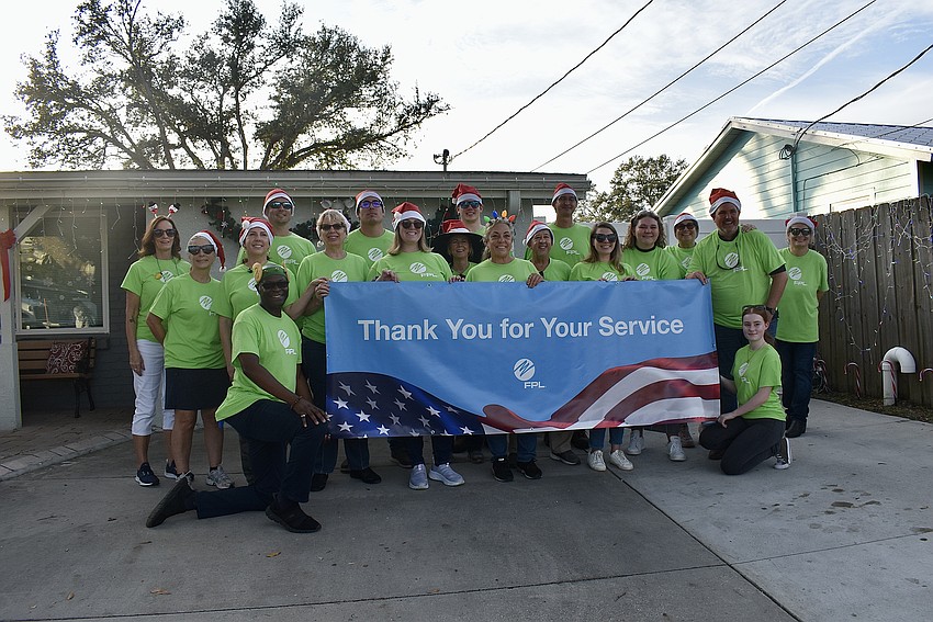 FPL and USF volunteers, a.k.a Elves, wait for the arrival of the Moreira family.