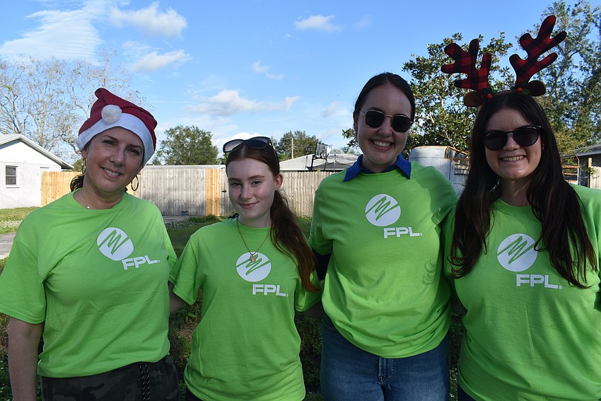 Clara Reynardus de Villanueva, Madison McMahon, Katie Kiselewski and Karina Bayona help with the holiday light decorations.