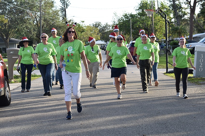 FPL and USF volunteers, a.k.a Elves, make way to get working on holiday light decorations.