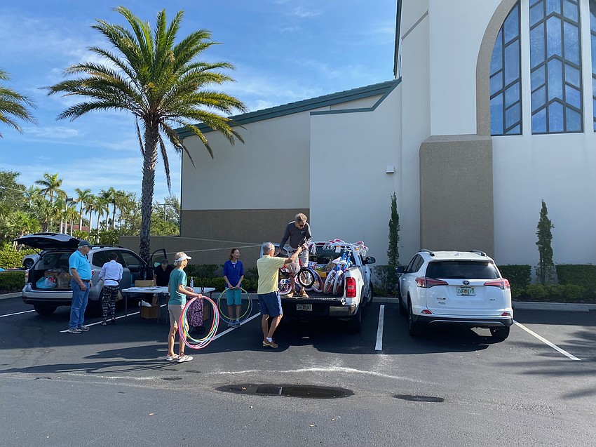 Christ Church members load up donations after a food and toy drive on Wednesday morning.