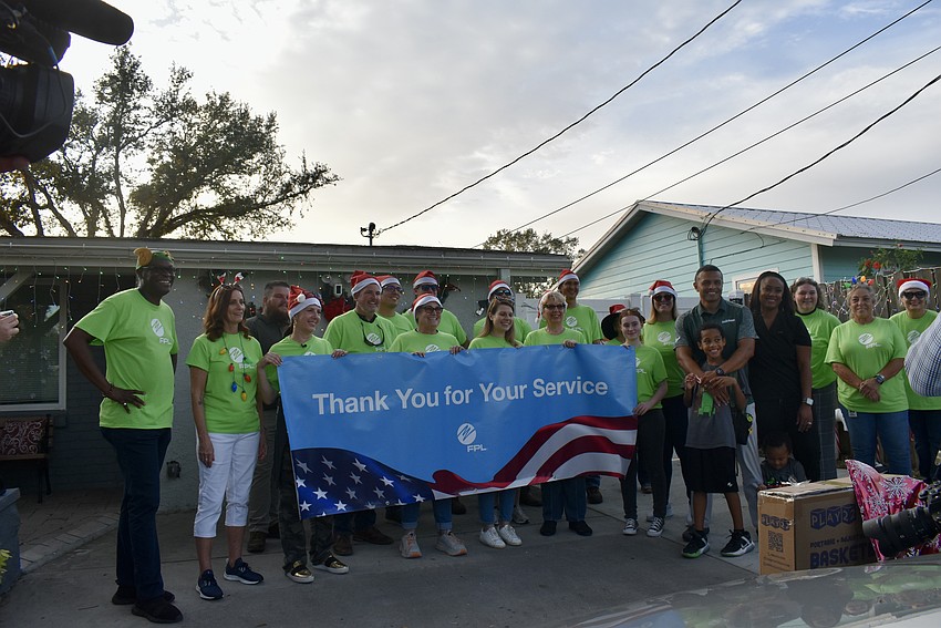 FPL, USF volunteers and the Moreira family gather together for pictures.