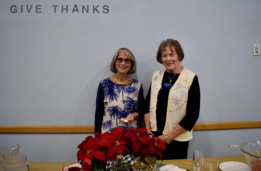 Mary Ruth Meyers and Nancy white serve water and punch at the reception.