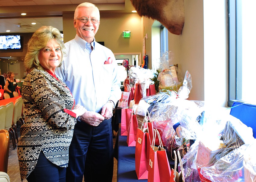 Concession's Zita Grepling and her husband, Bob Grepling, look at the various raffle prizes. 