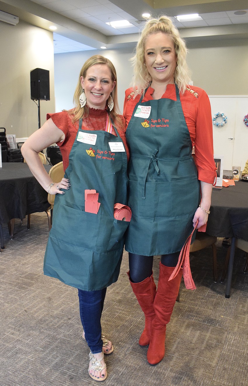 Sarasota's Melissa Ferlazzo, a database administrator for Meals on Wheels Plus of Manatee, and Lakewood Ranch's Julianne Niebour sell raffle tickets.