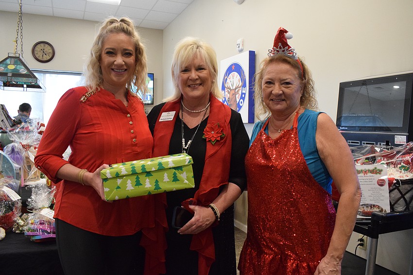 Lakewood Ranch's Julianne Niebour, Maribeth Phillips, the CEO and president of Meals on Wheels Plus of Manatee, and Myakka City's Tonya Ditty collect shoeboxes.