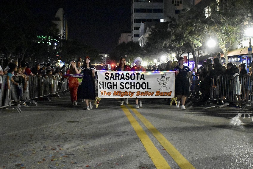 Sarasota High School make their down Main Street.