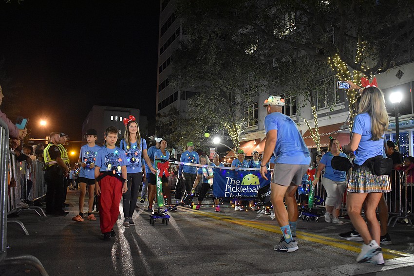 The Pickleball Club play a game as they walk down Main Street.