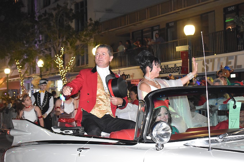 Pedro Reis and Dolly Jacobs waves at the Sarasota parade goers.