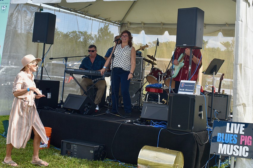 Joyce Welch dance walks by the band tent.