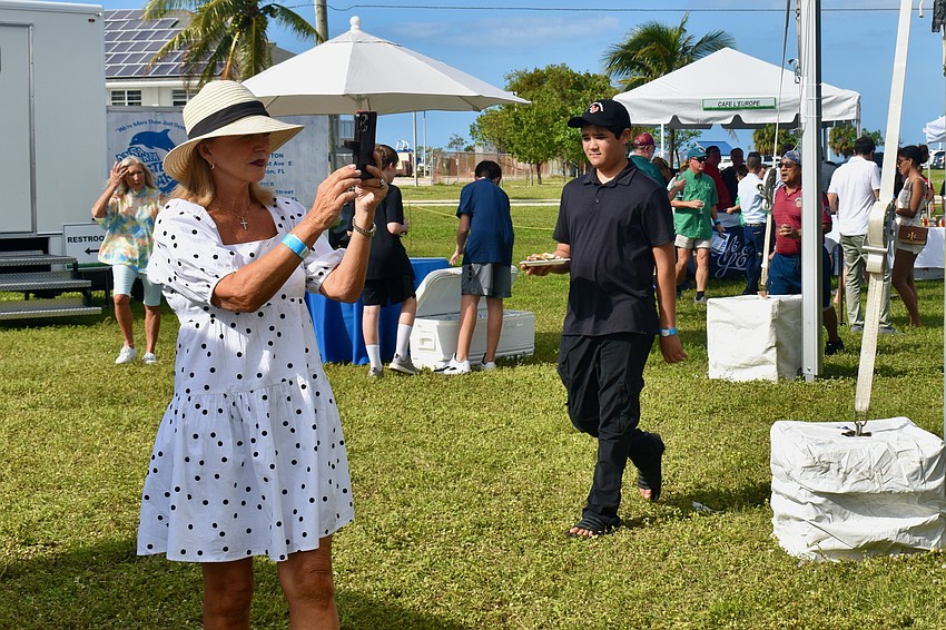 Regina Jellicoe stops to take a video.