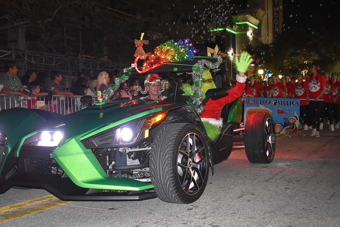The Grinch rides in style at the Sarasota Holiday Parade on Dec. 3, 2022.