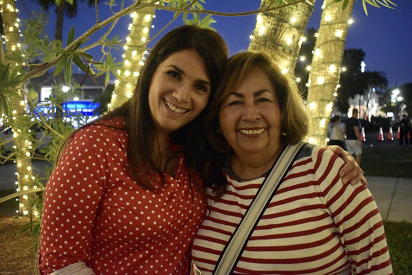 Marjorie Reda and Migda Cubero wait for the lighting of the 60 foot tree.